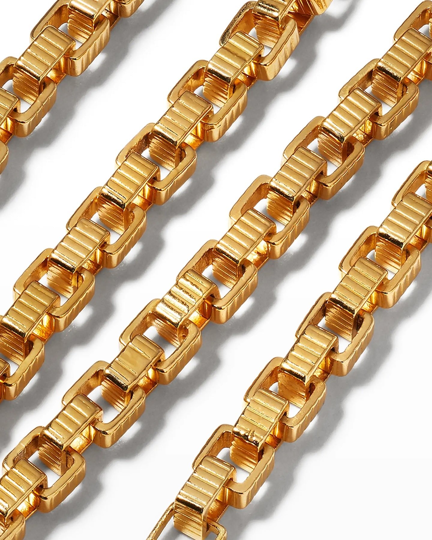 A close up of a gold-plated chain necklace with a square clasp, displayed on a white background.