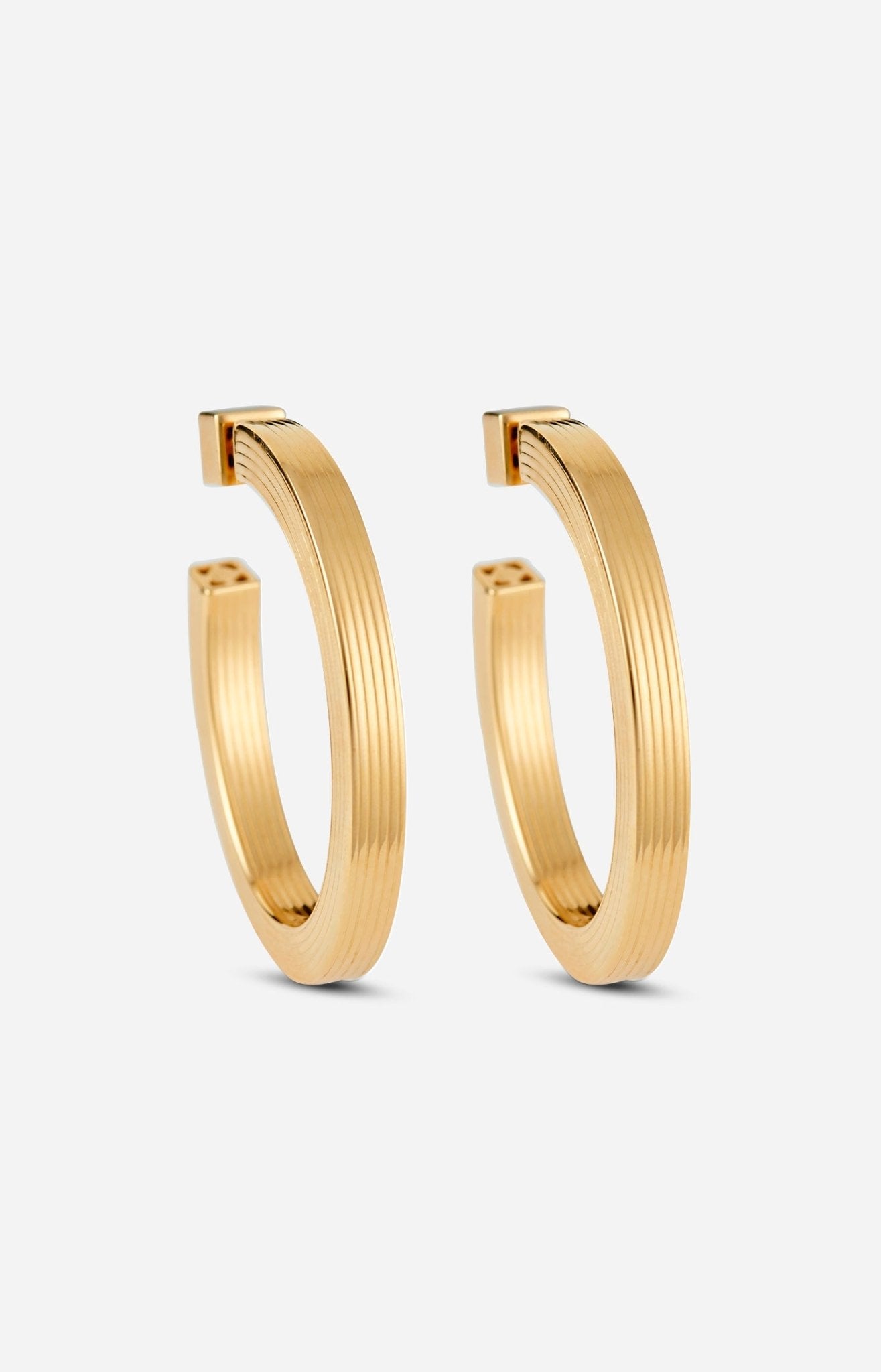 A pair of gold-plated hoop earrings with a square post, displayed against a white background.
