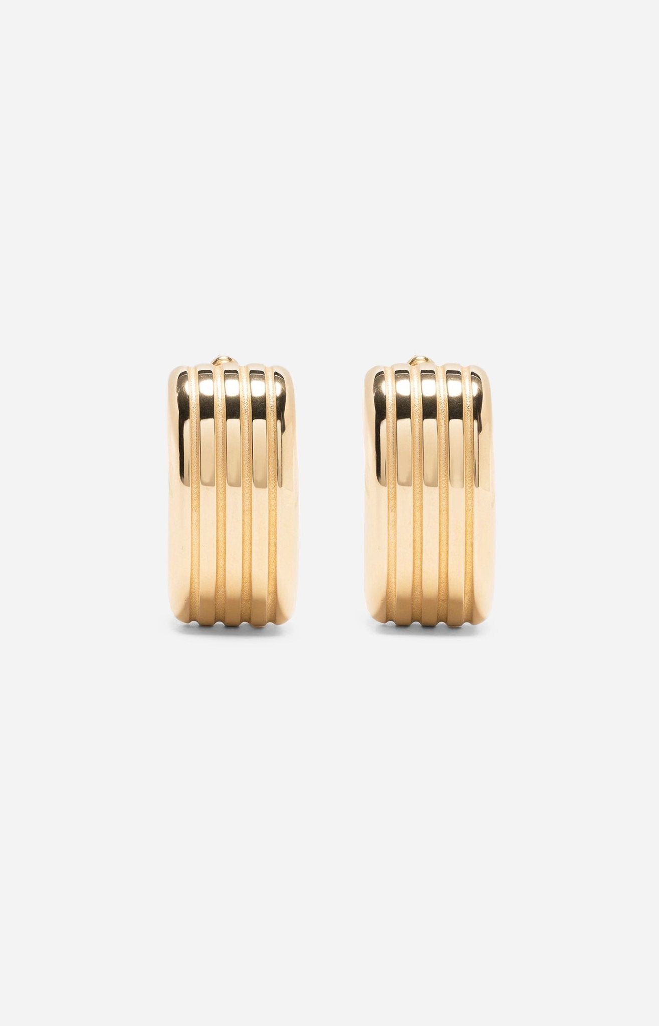 A pair of gold-plated oval hoop earrings on a white background.