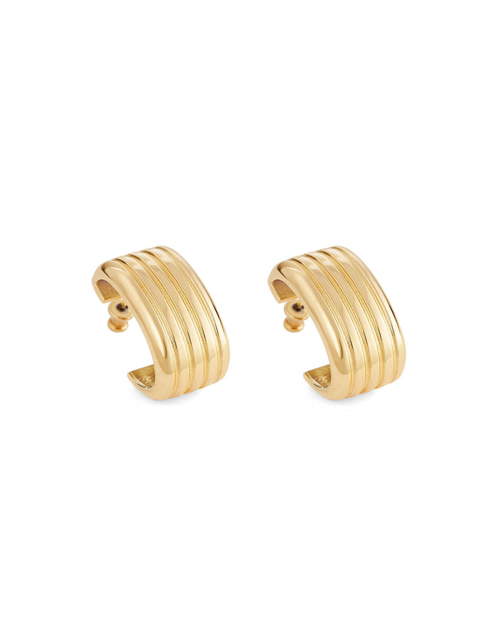A pair of gold-plated oval hoop earrings on a white background.