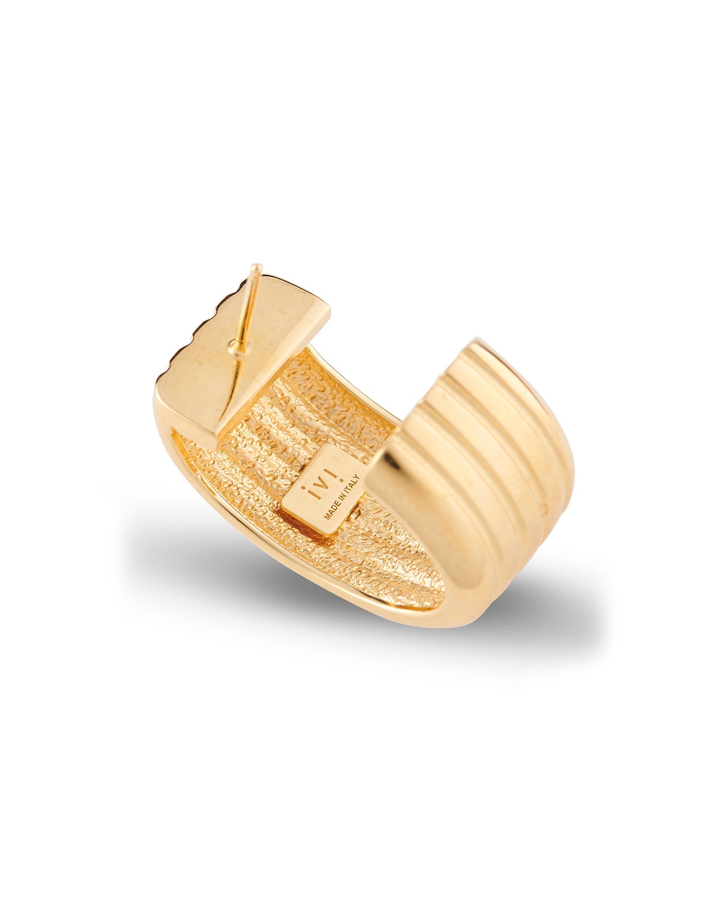 A gold-plated oval hoop earring on a white background.