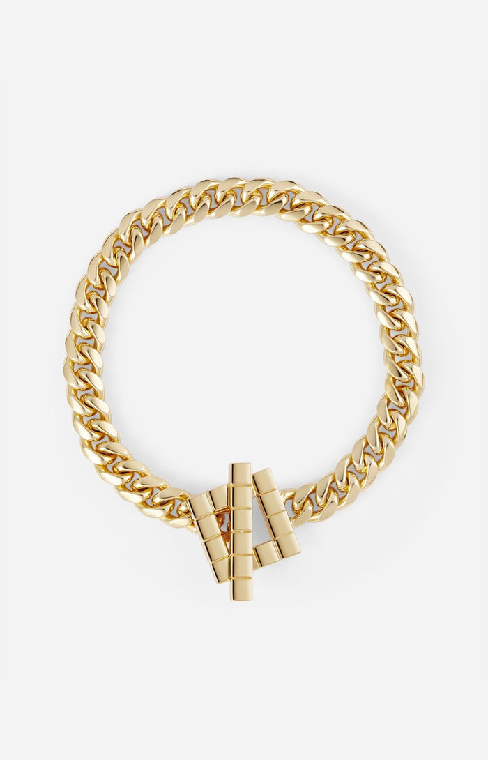 A gold-plated chunky chain necklace with a sculptural geometric clasp on a white background.