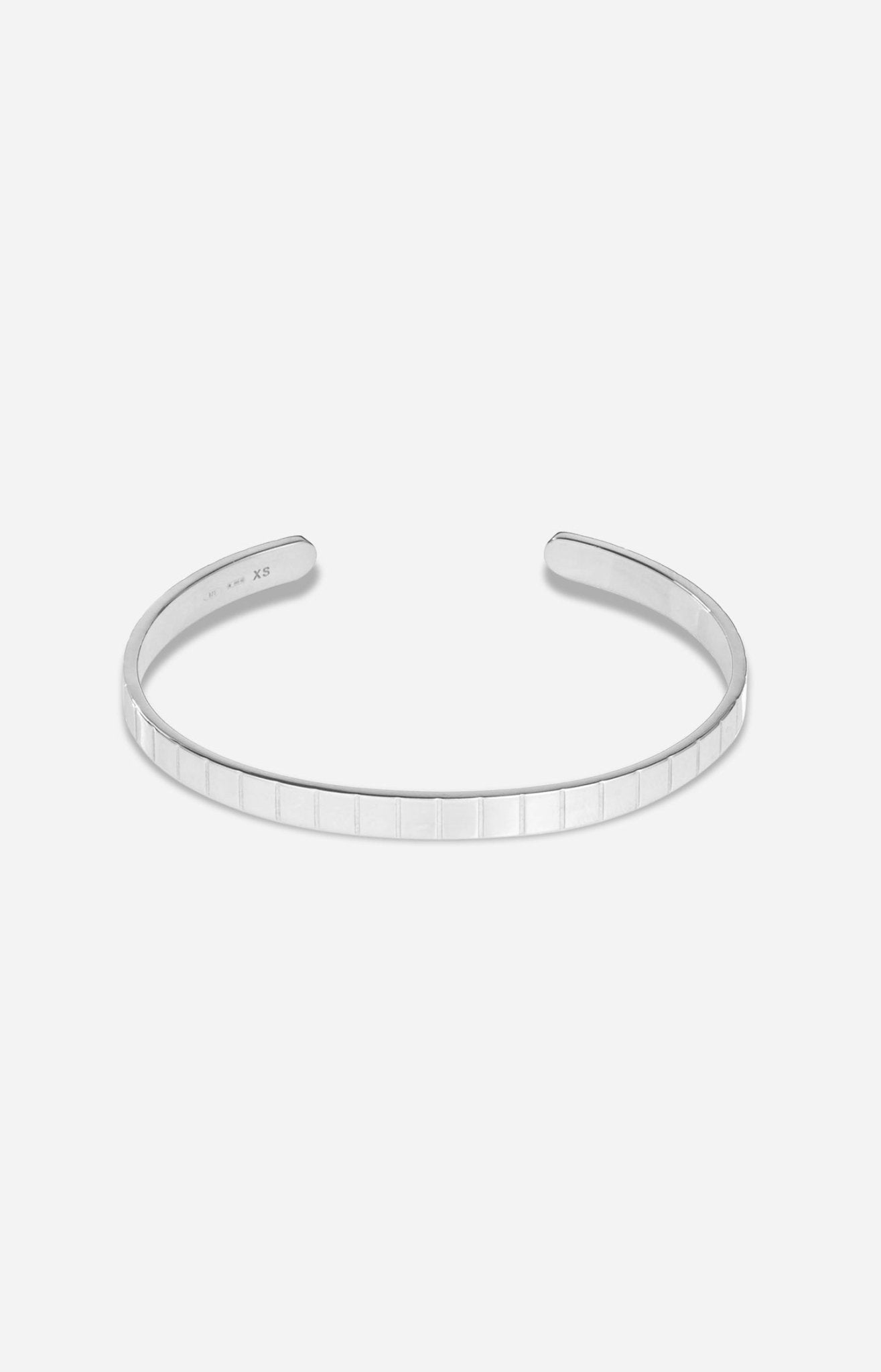 A rhodium-plated single slot cuff bracelet with a grooved profile on a white background.