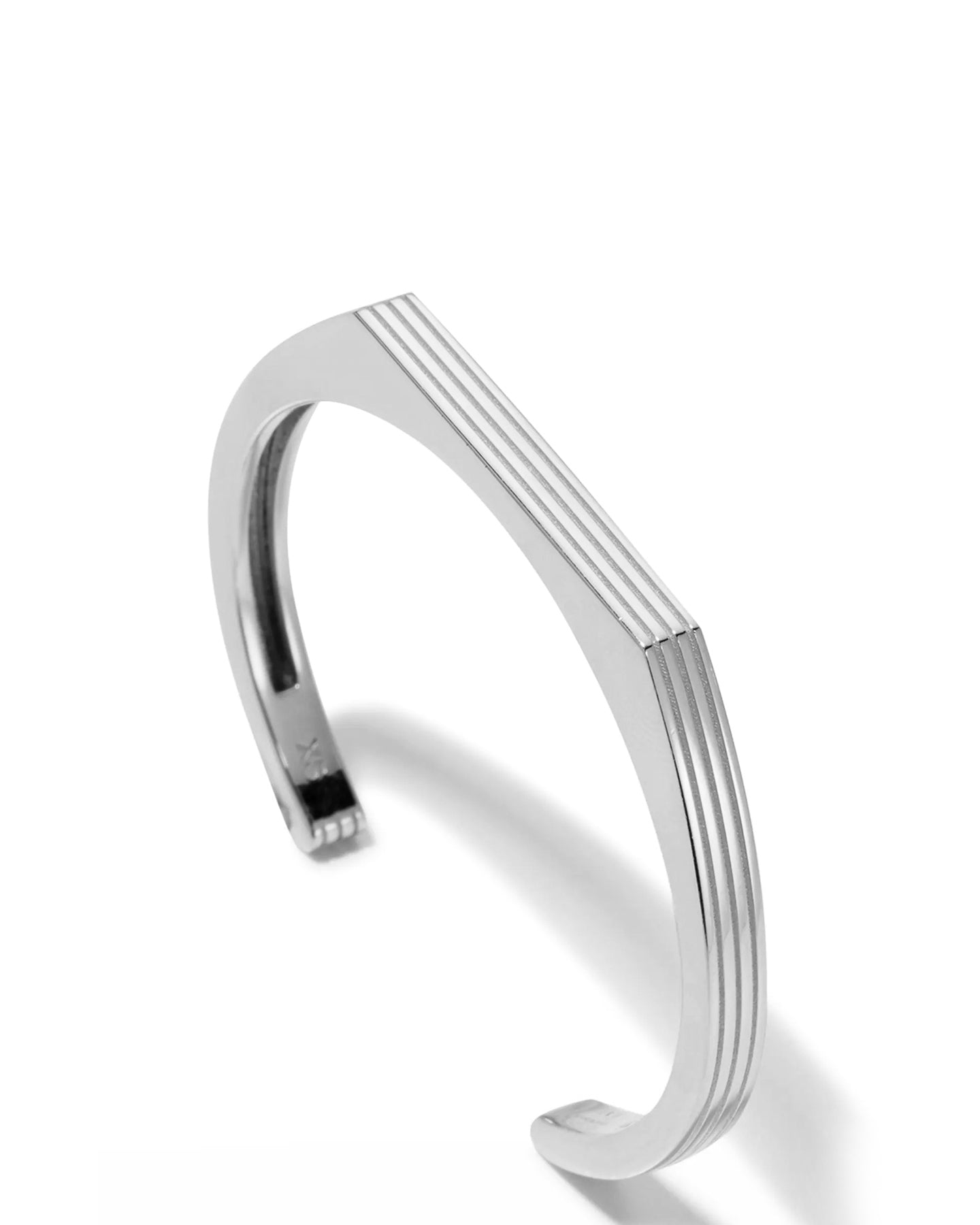 A rhodium-plated cuff bracelet with a sleek, modern design displayed on a white background. 