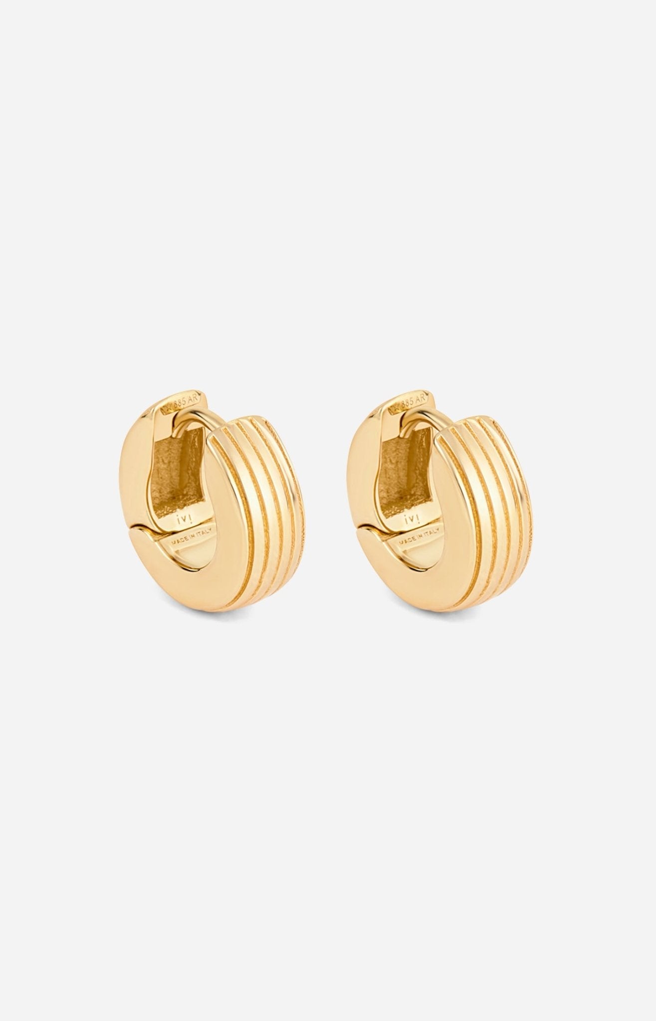 A pair of gold-plated round huggies earrings with a slim curved silhouette and engraved detailing on a white background.