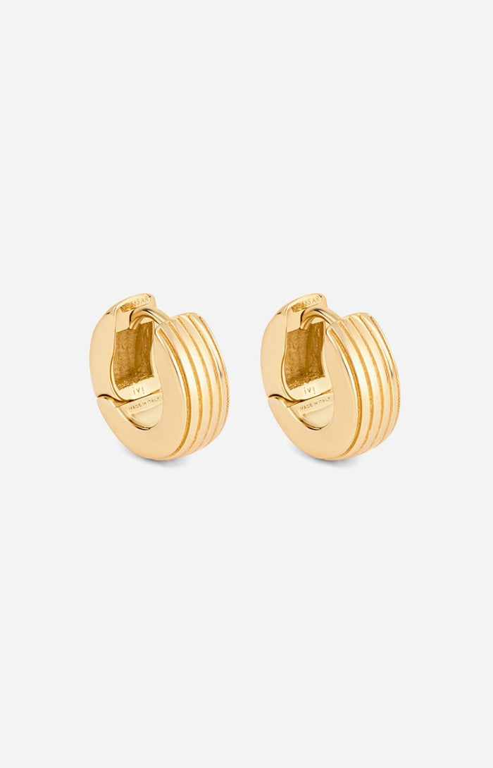 A pair of gold-plated round huggies earrings with a slim curved silhouette and engraved detailing on a white background.