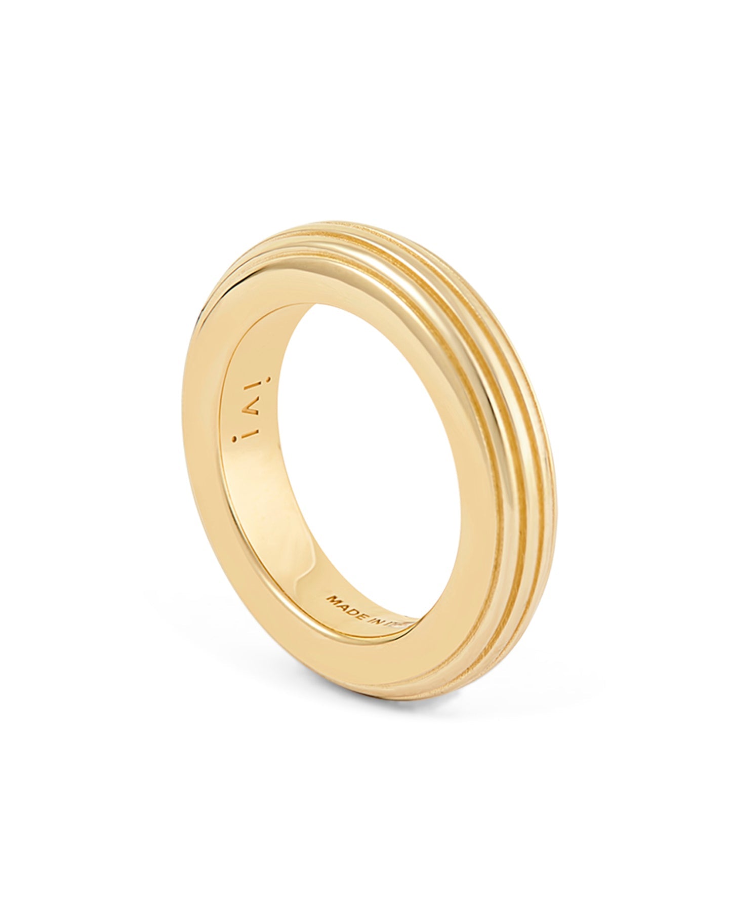 A gold-plated, round-shaped ring with linear engravings on a white background.