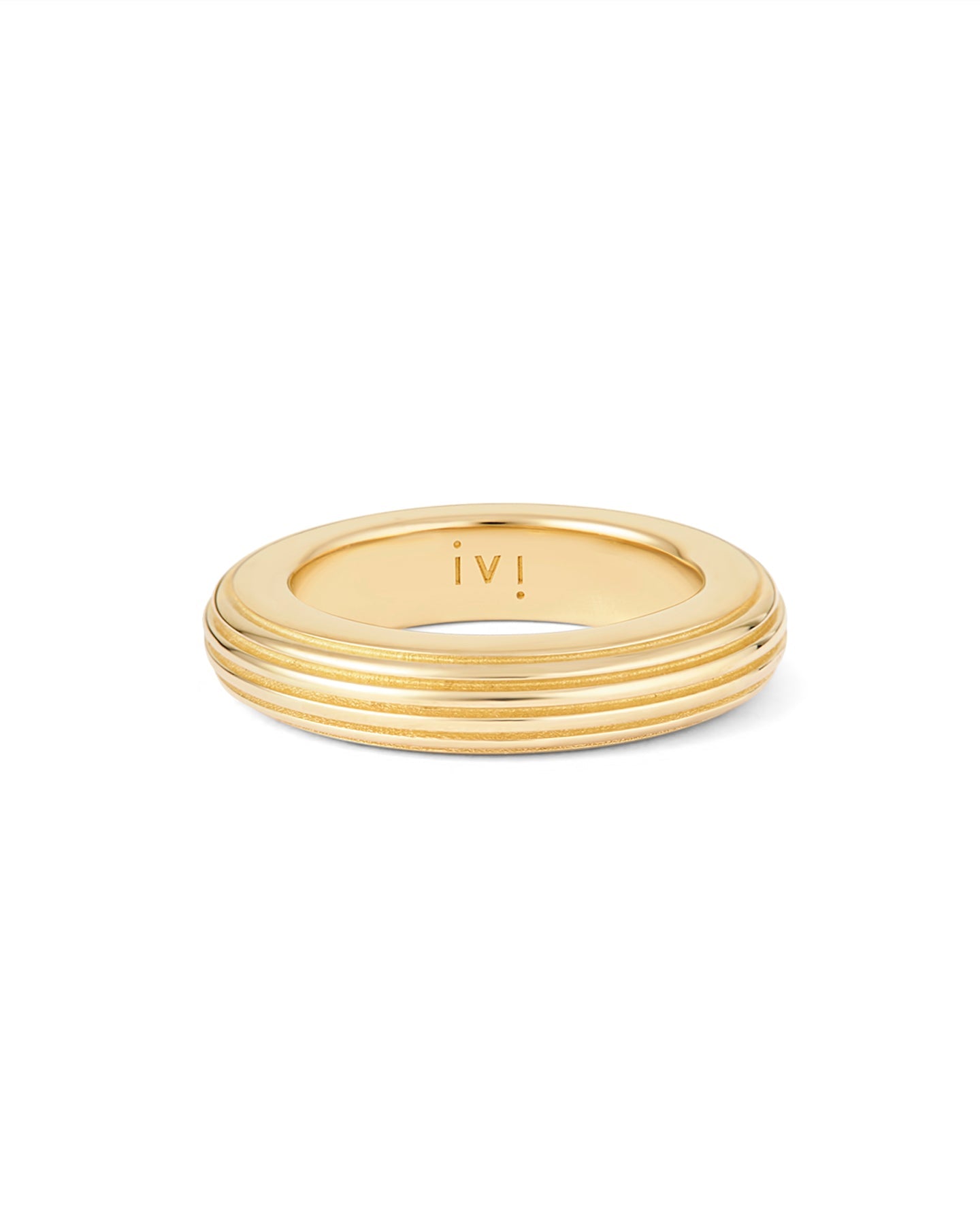 A gold-plated, round-shaped ring with linear engravings on a white background.
