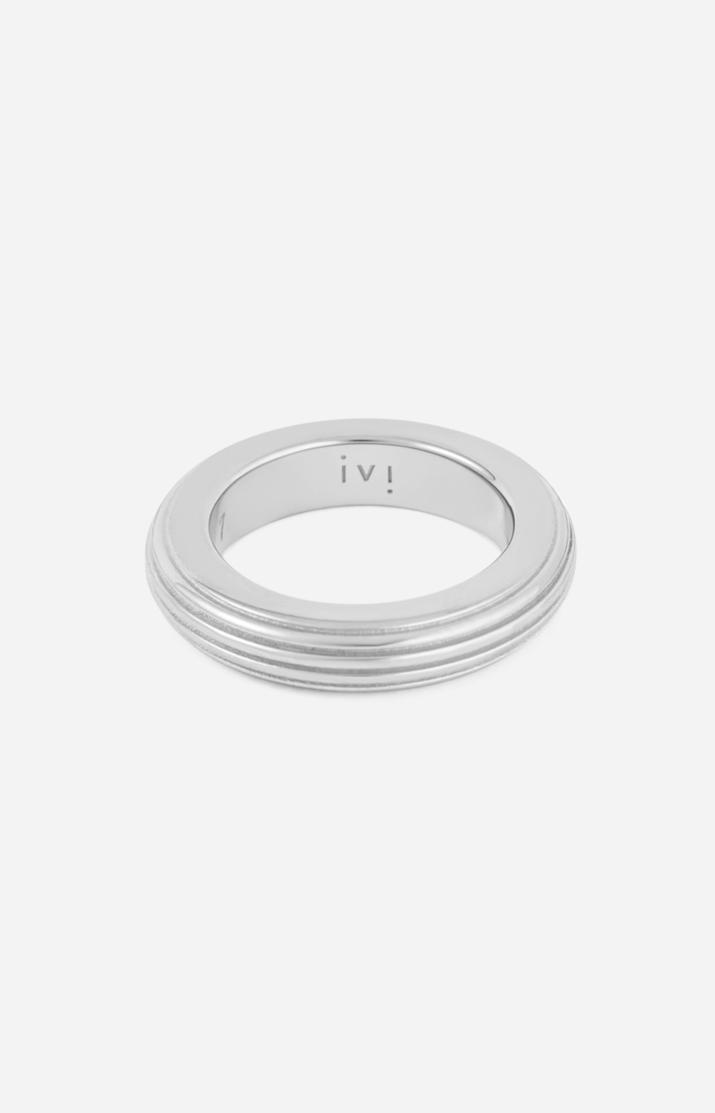 A rhodium-plated, round-shaped ring with linear engravings on a white background.