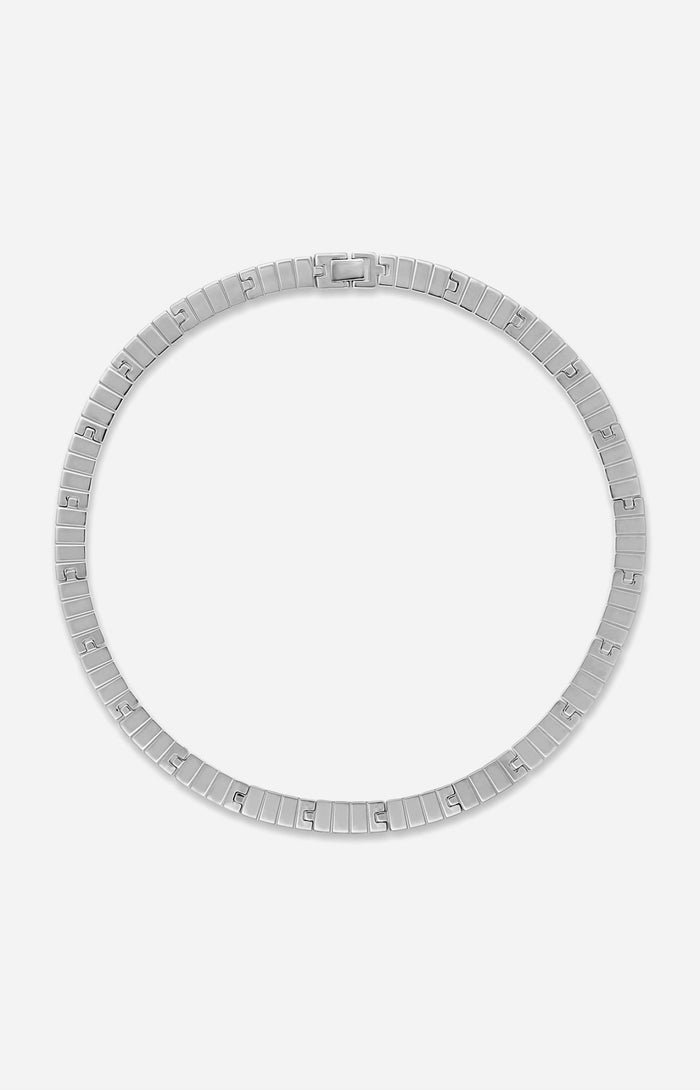 A rhodium-plated slot chain necklace with a custom clasp, laid out on a plain background.