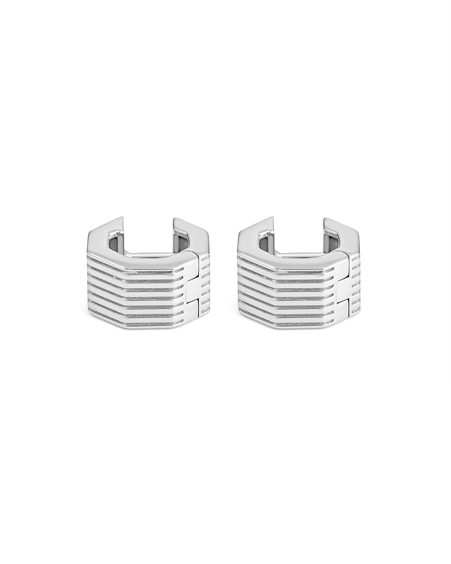 A pair of rhodium-plated wide octagon huggie earrings with a signature angular silhouette, designed to comfortably hug the lobe.