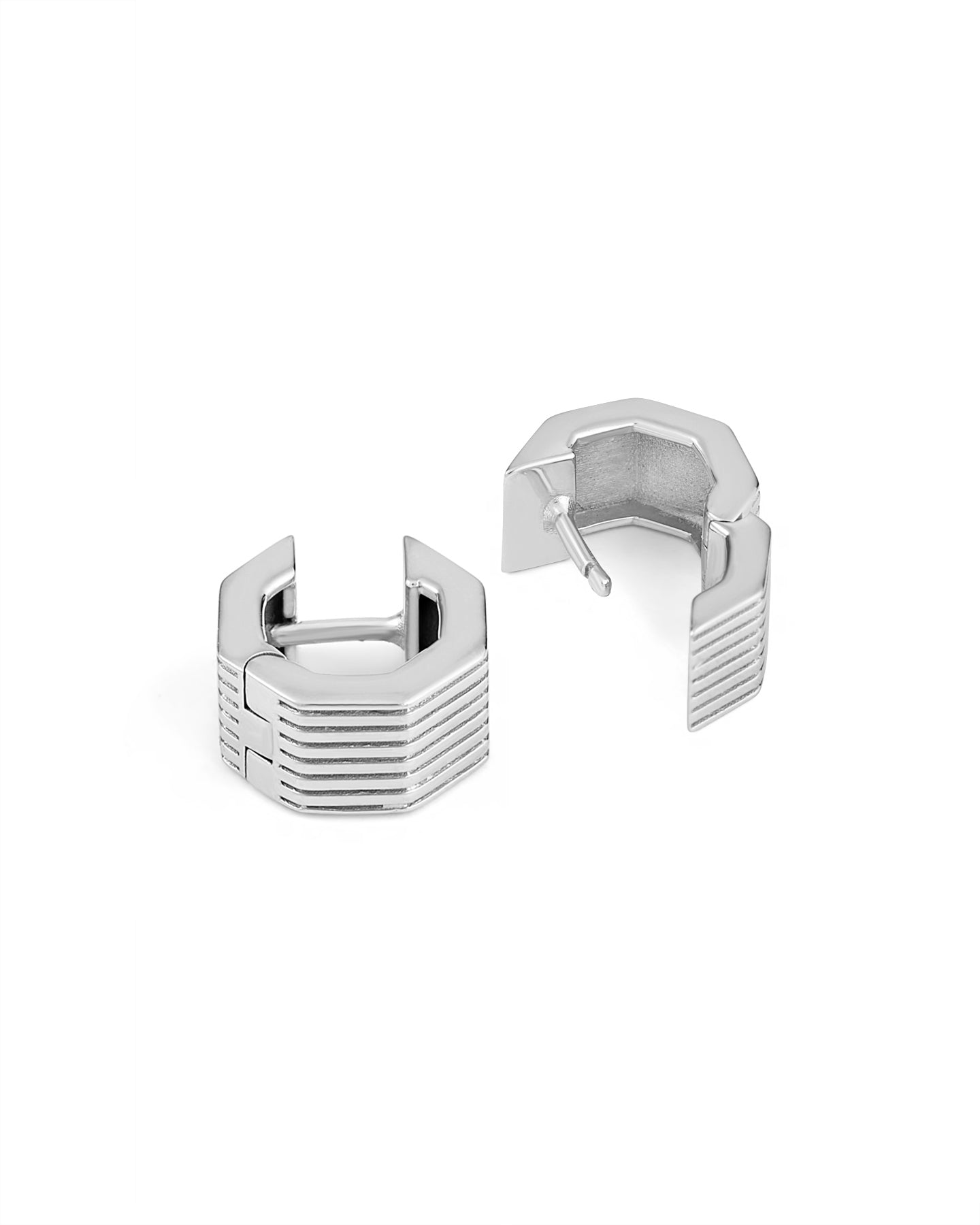A pair of rhodium-plated wide octagon huggie earrings with a signature angular silhouette, designed to comfortably hug the lobe.