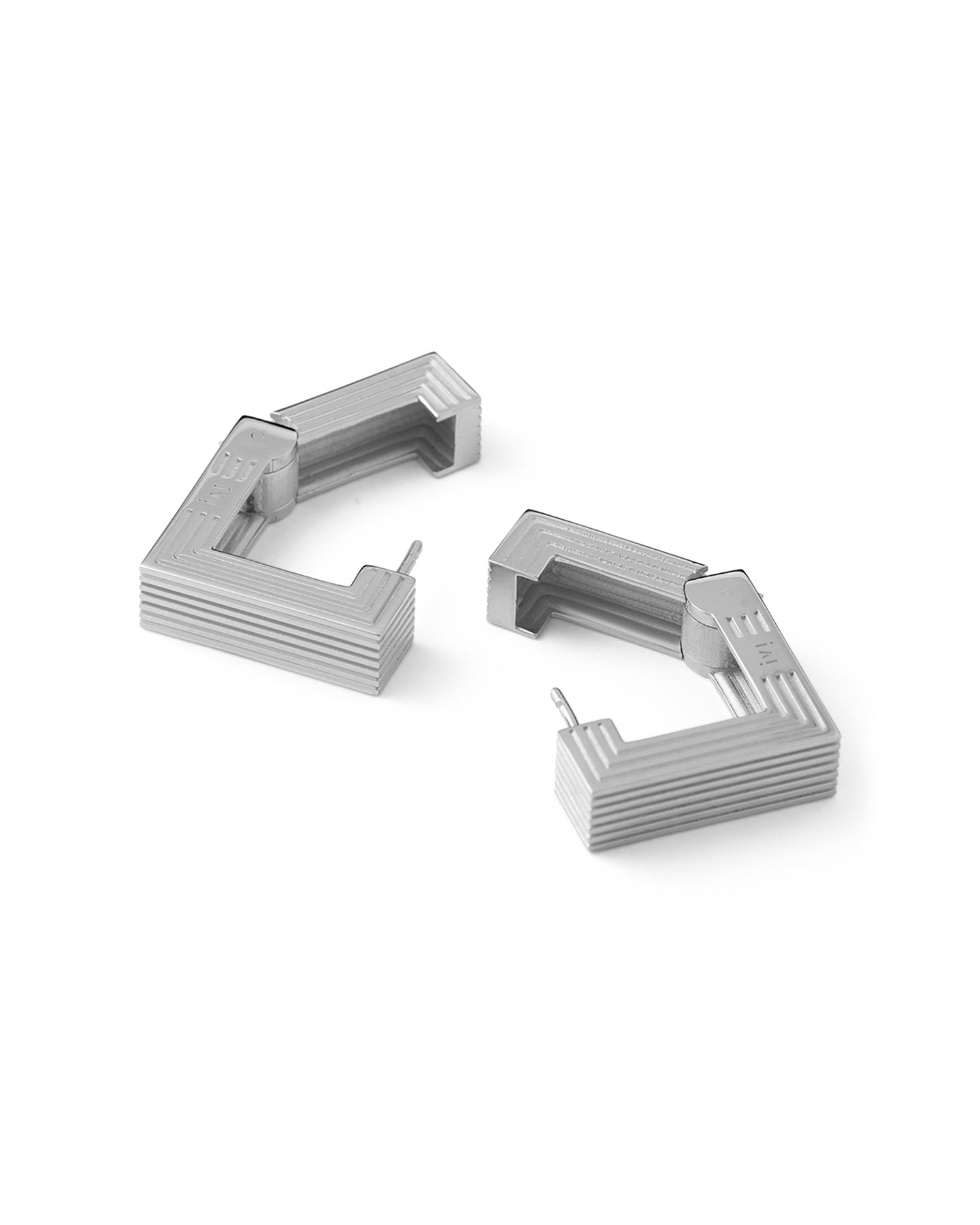 Pair of rhodium-plated medium Aurelia sculptural square hoop earrings on a white background.