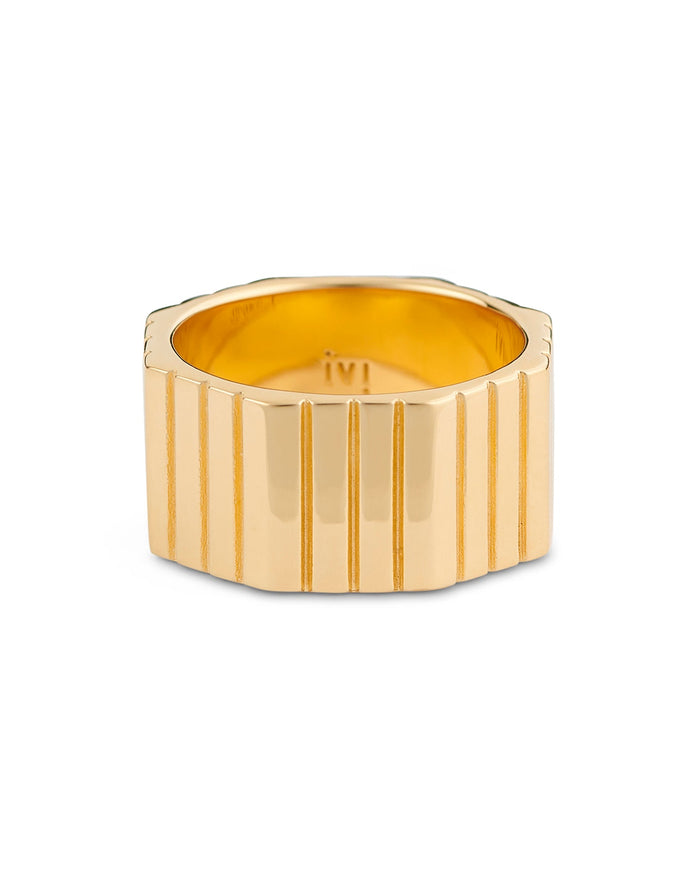 A gold-plated, octagonal-shaped ring with linear engravings on the band