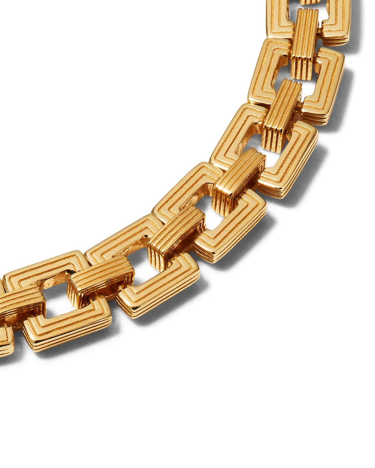 A close up of a gold-plated Aurelia Chain bracelet with interlocking square links displayed on a white background.