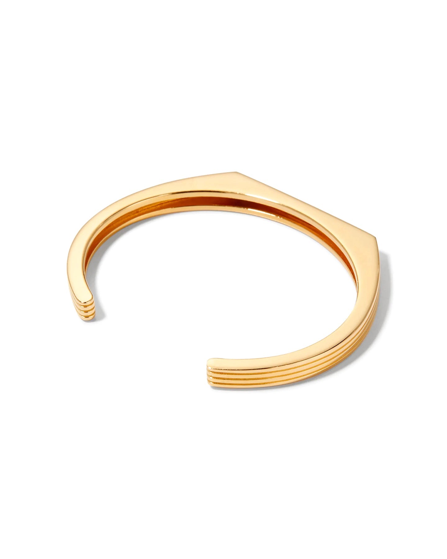 A gold-plated cuff bracelet with a sleek, modern design displayed on a white background. 